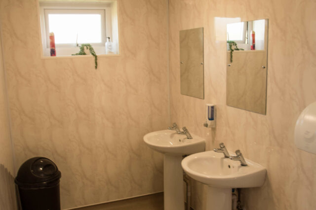 Two sinks and mirrors in a caravan site toilet facility